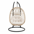Fauteuil suspendu en rotin beige avec structure en acier